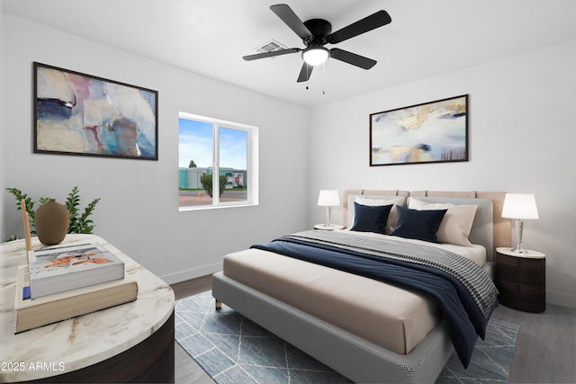 bedroom with visible vents, a ceiling fan, baseboards, and wood finished floors