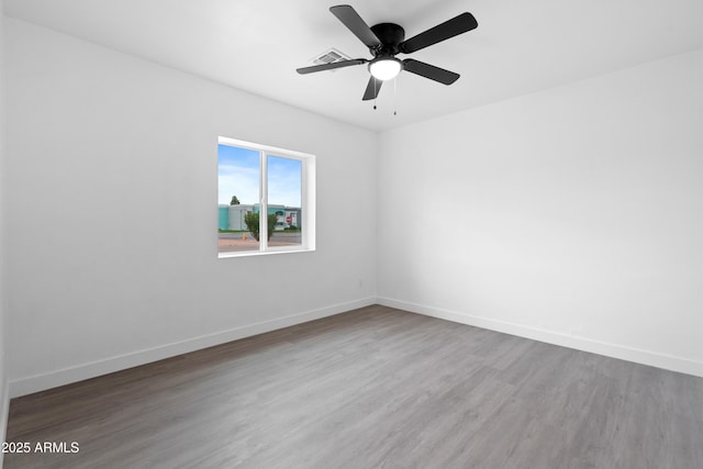 unfurnished room with wood finished floors, baseboards, and ceiling fan