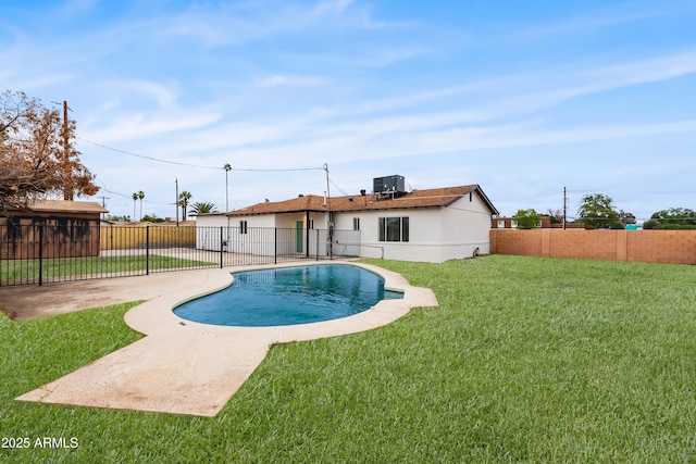 view of pool featuring a patio, a fenced backyard, a yard, a fenced in pool, and central AC unit