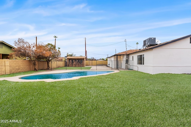 view of pool with a fenced in pool, a lawn, central AC unit, and a fenced backyard