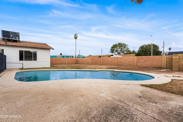 view of pool featuring a patio, cooling unit, a fenced backyard, and a fenced in pool