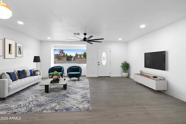 living room with visible vents, recessed lighting, baseboards, and wood finished floors