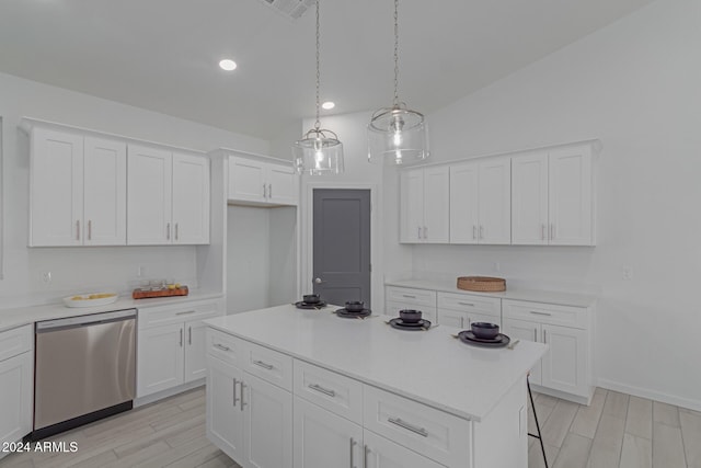 kitchen with white cabinets, vaulted ceiling, a center island, and stainless steel dishwasher