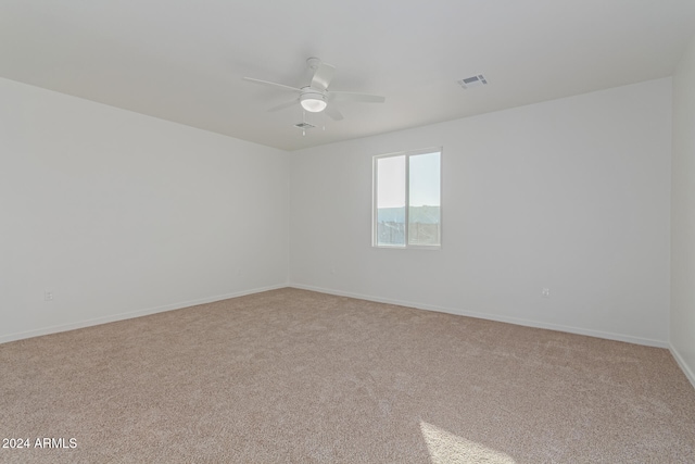 unfurnished room with light colored carpet and ceiling fan