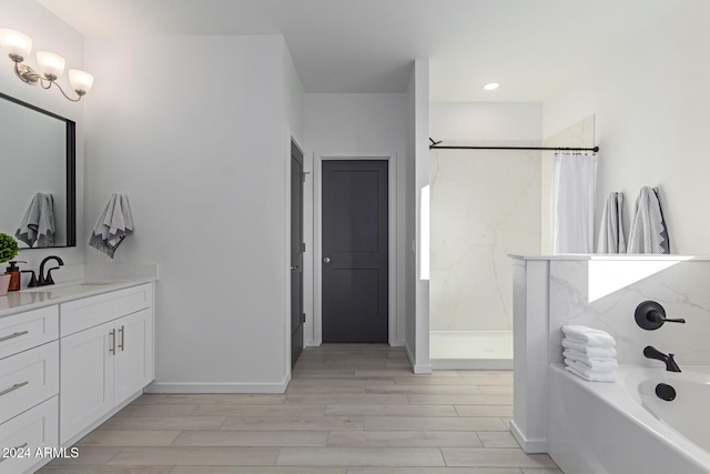 bathroom with hardwood / wood-style floors, vanity, and separate shower and tub