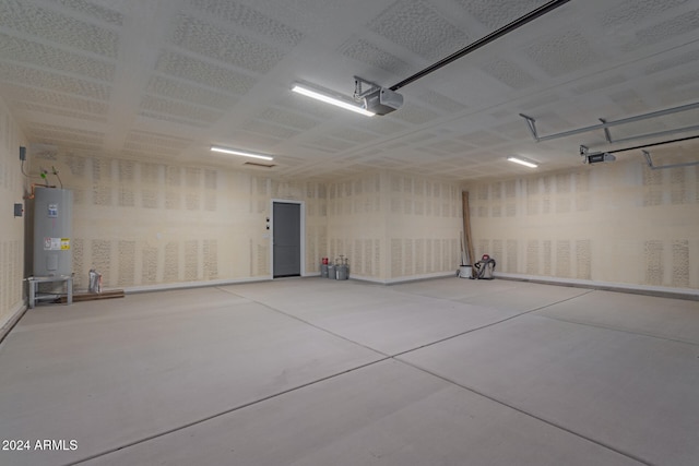 garage with electric water heater and a garage door opener