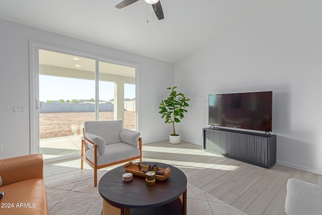 living room with light hardwood / wood-style flooring and ceiling fan