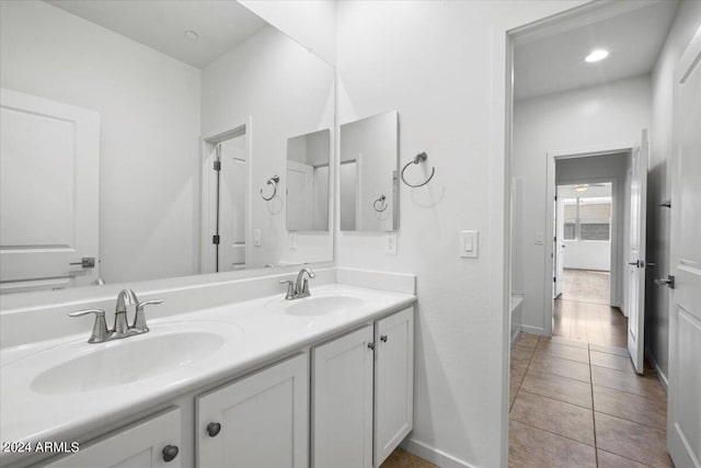 bathroom featuring hardwood / wood-style flooring and dual bowl vanity