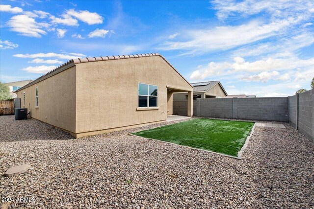 back of house with cooling unit and a patio area