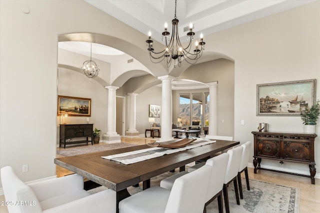 dining room with decorative columns, a high ceiling, and light tile patterned floors