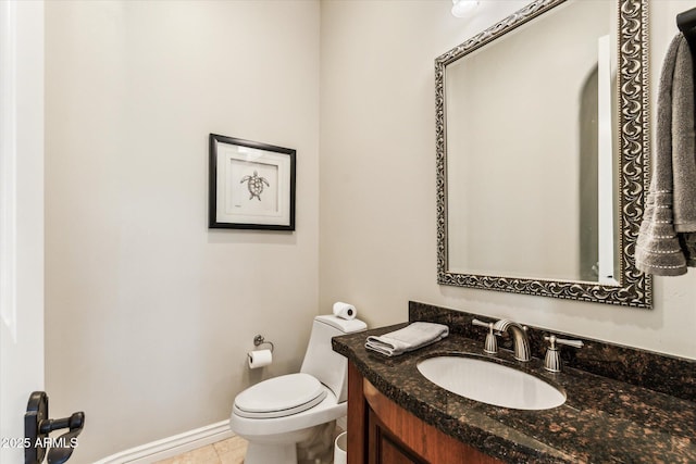 bathroom with vanity, tile patterned flooring, and toilet