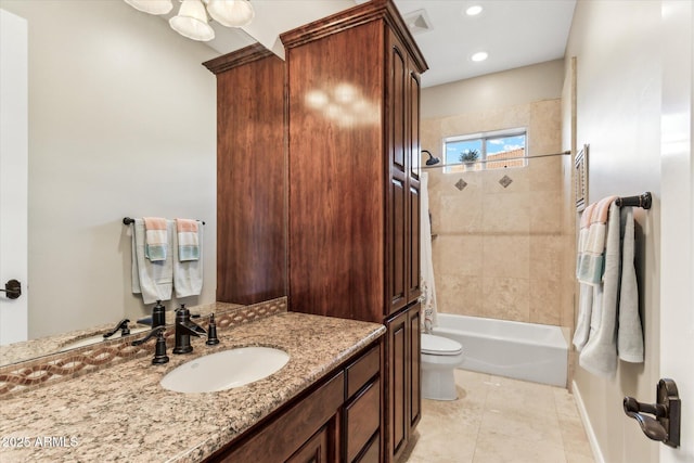 full bathroom with tiled shower / bath combo, vanity, tile patterned floors, and toilet