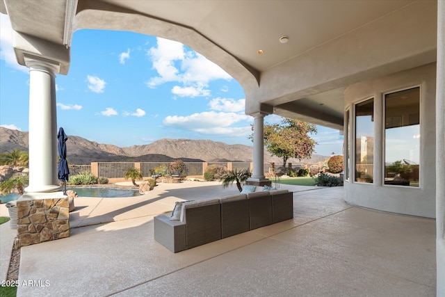 view of patio with a mountain view and a fenced in pool