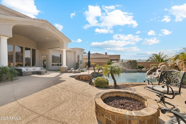 view of pool with a fire pit and a patio area