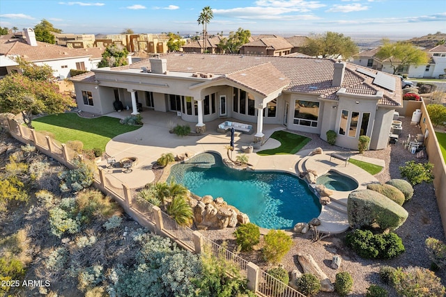 view of swimming pool featuring a patio and an in ground hot tub