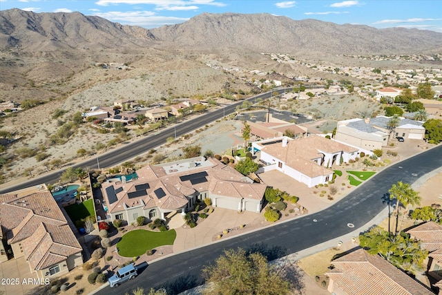 birds eye view of property with a mountain view