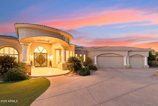 mediterranean / spanish-style home with french doors and a garage