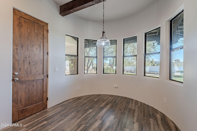 empty room featuring wood-type flooring and beam ceiling