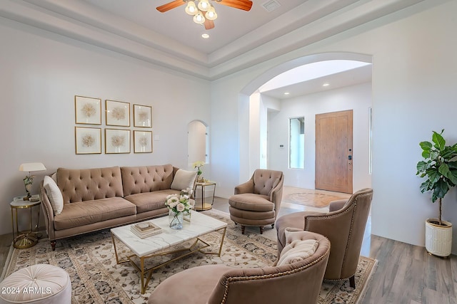 living room with wood-type flooring and ceiling fan