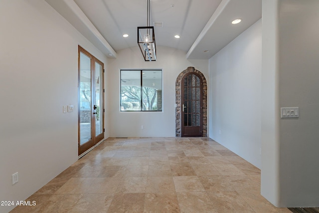 interior space featuring french doors and vaulted ceiling