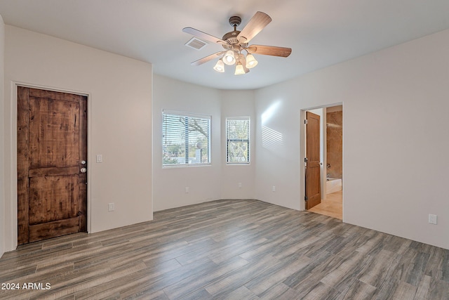 empty room with ceiling fan and wood-type flooring