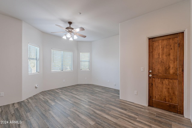 spare room with ceiling fan and wood-type flooring