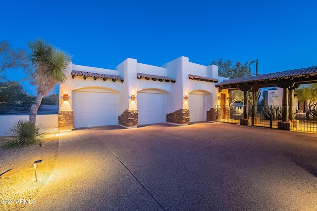7845 E Dynamite Blvd, Scottsdale, AZ 85266 - mediterranean / spanish house featuring a garage, stone siding, stucco siding, and driveway