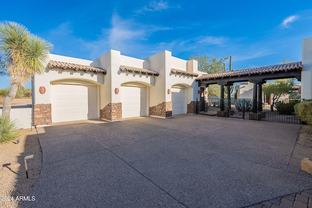 7845 E Dynamite Blvd, Scottsdale, AZ 85266 - mediterranean / spanish home featuring a garage, concrete driveway, stone siding, and stucco siding