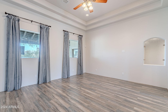 7845 E Dynamite Blvd, Scottsdale, AZ 85266 - empty room with ceiling fan, wood finished floors, and healthy amount of natural light