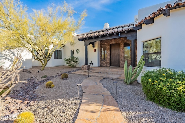 entrance to property with a patio area