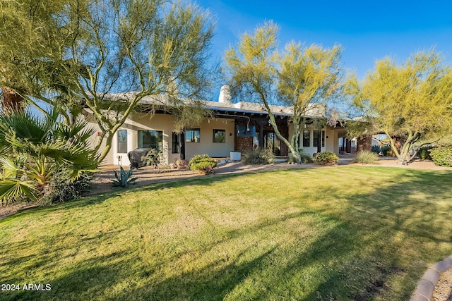 7845 E Dynamite Blvd, Scottsdale, AZ 85266 - rear view of house featuring a lawn and stucco siding