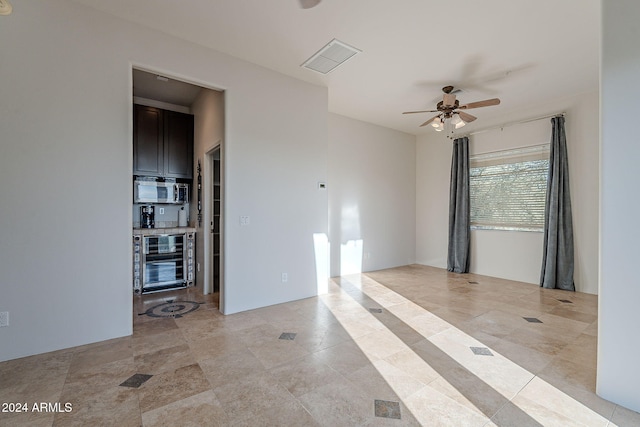 7845 E Dynamite Blvd, Scottsdale, AZ 85266 - spare room featuring wine cooler, a ceiling fan, and light tile patterned floors