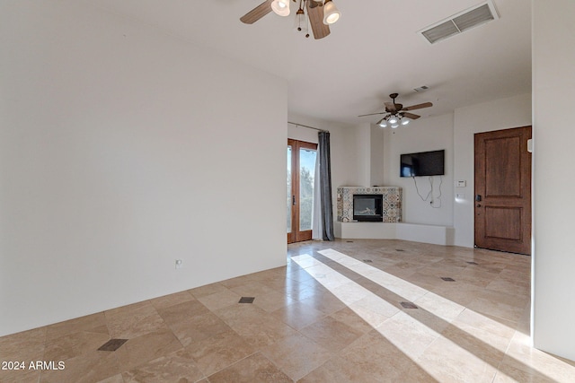 7845 E Dynamite Blvd, Scottsdale, AZ 85266 - unfurnished living room featuring a ceiling fan and a glass covered fireplace