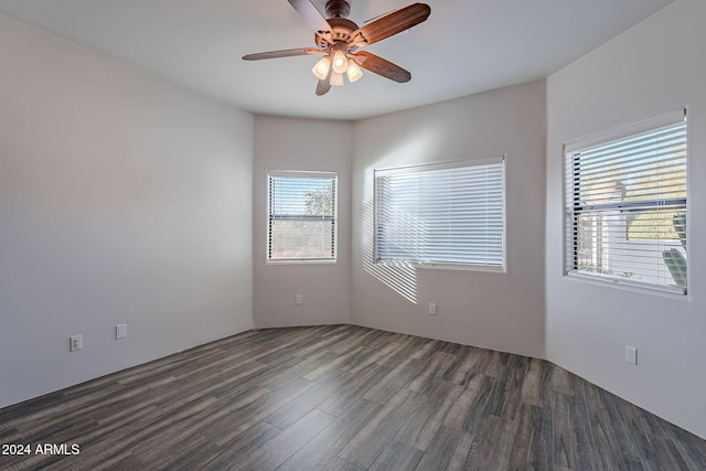 empty room with ceiling fan and dark hardwood / wood-style flooring