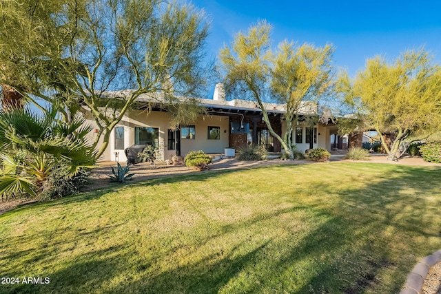 rear view of property with a yard