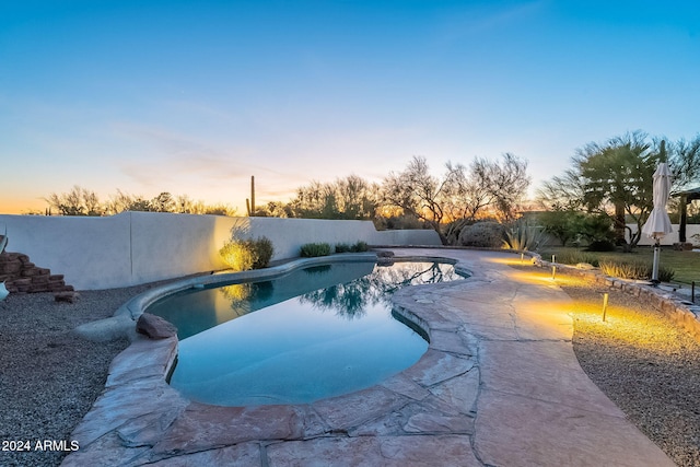 7845 E Dynamite Blvd, Scottsdale, AZ 85266 - pool at dusk featuring a fenced backyard and a patio area