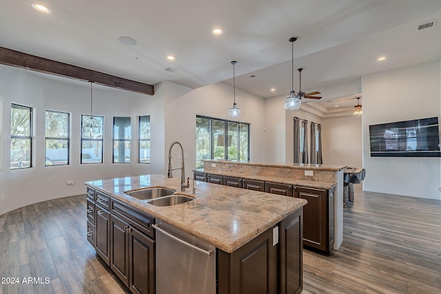 kitchen featuring sink, stainless steel dishwasher, dark hardwood / wood-style floors, pendant lighting, and a kitchen island with sink