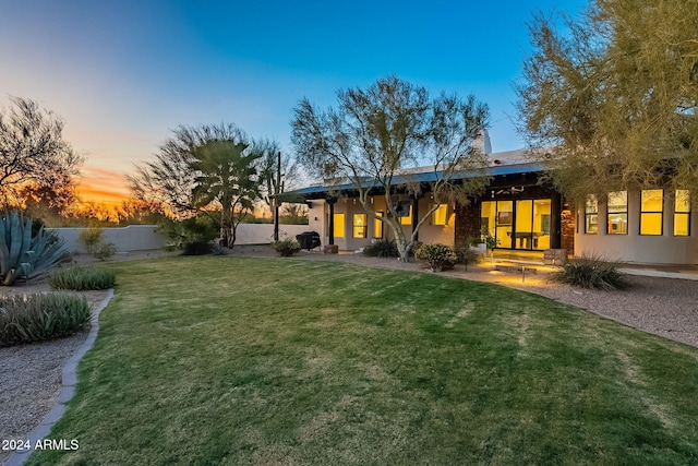 view of yard at dusk