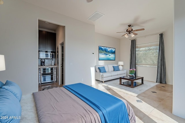 7845 E Dynamite Blvd, Scottsdale, AZ 85266 - bedroom featuring beverage cooler, light tile patterned floors, and a ceiling fan