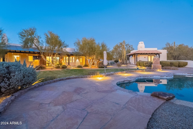 pool at dusk with a yard