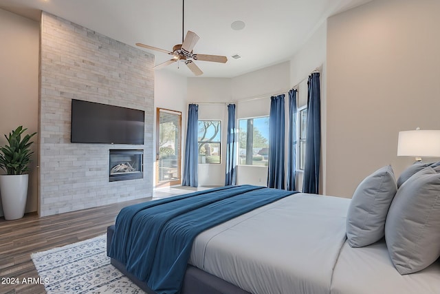 7845 E Dynamite Blvd, Scottsdale, AZ 85266 - bedroom featuring wood finished floors, a fireplace, and a ceiling fan
