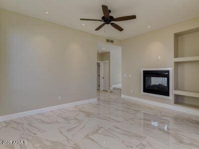3634 N Desert Oasis, Mesa, AZ 85207 - unfurnished living room with built in shelves, marble tiled floors, a multi sided fireplace, a ceiling fan, and baseboards