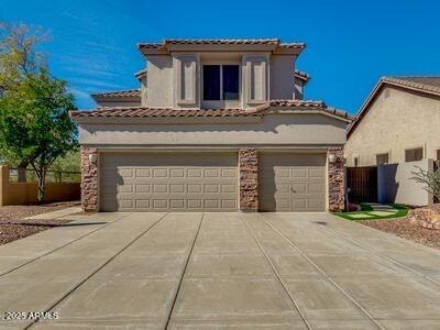 3634 N Desert Oasis, Mesa, AZ 85207 - mediterranean / spanish home with driveway, an attached garage, and stucco siding