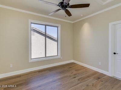3634 N Desert Oasis, Mesa, AZ 85207 - unfurnished room featuring crown molding, wood finished floors, baseboards, and ceiling fan