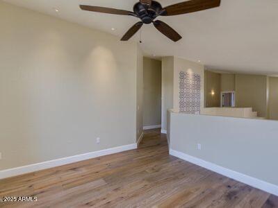 3634 N Desert Oasis, Mesa, AZ 85207 - unfurnished living room with wood finished floors, baseboards, and ceiling fan