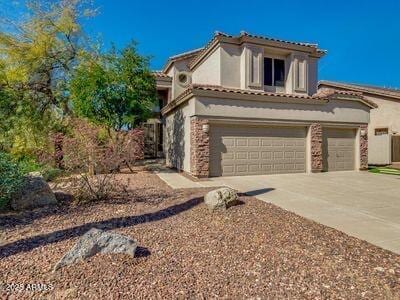 3634 N Desert Oasis, Mesa, AZ 85207 - mediterranean / spanish house with stucco siding, concrete driveway, a garage, and a tiled roof