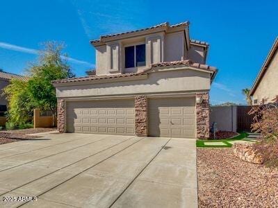 3634 N Desert Oasis, Mesa, AZ 85207 - mediterranean / spanish home featuring stucco siding, driveway, a garage, and a tiled roof