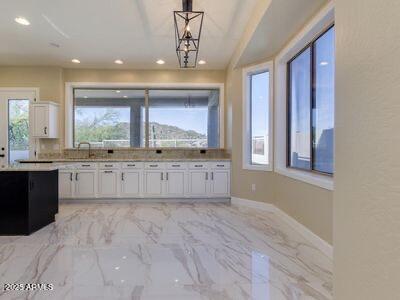3634 N Desert Oasis, Mesa, AZ 85207 - kitchen featuring white cabinetry, decorative light fixtures, recessed lighting, baseboards, and light marble finish floors