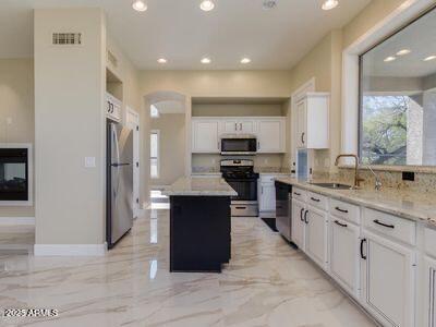 3634 N Desert Oasis, Mesa, AZ 85207 - kitchen with stainless steel appliances, recessed lighting, plenty of natural light, a sink, and white cabinetry