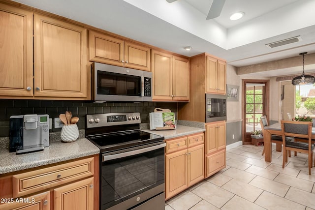 kitchen with visible vents, light tile patterned floors, baseboards, appliances with stainless steel finishes, and backsplash